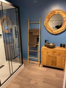 a room with a mirror and a wooden table at Sweet Dreams by Pegase in Vlezenbeek