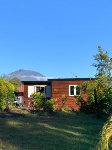 a house on a hill with a yard at Chalet des capucines in La Plaine des Palmistes