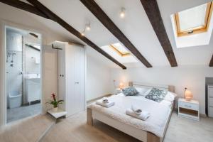 a bedroom with a large bed and a bathroom at Central apartments in Pula