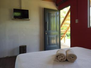 ein Schlafzimmer mit einem Bett mit Handtüchern darauf in der Unterkunft El Limbo Posada in Tigre