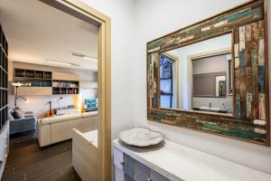 un salon avec un miroir et un canapé dans l'établissement Verde Ferienhaus mit Panorama-Seeblick, à Pianello Del Lario 43 autres photos