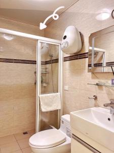 a bathroom with a shower and a toilet and a sink at 逢甲美學院 in Taichung
