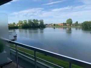 a view of a large river with a railing at Studio Laguna Beach Knokke-Heist in Knokke-Heist