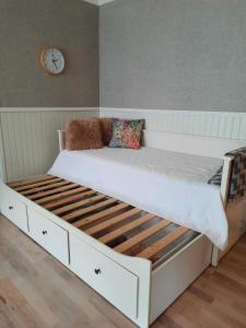 a large white bed with a wooden frame in a room at Aalto 17 in Haapsalu +6 photos