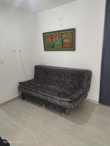 un sofá en una habitación con una pintura en la pared en Apartamento en el norte con parqueadero y vista, en Armenia