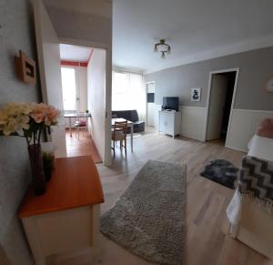 a living room with a couch and a dining room at Aalto 17 in Haapsalu