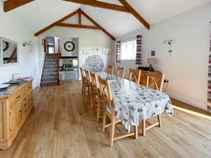 a kitchen and dining room with a table and chairs at Old Mill- 23398 in Bradworthy