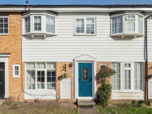 a white house with a blue door and windows at Pass the Keys Stylish Family Friendly 3 Bed Home in Borehamwood in Borehamwood