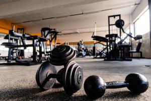 a gym with weights laying on the floor at Garden Hotel in Campina Grande