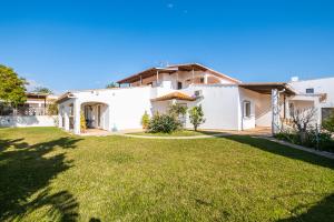 a house with a lawn in front of it at Villa Estrelícia - Pool - Free wi-fi - New in Booking in Loulé