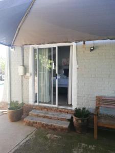 a porch of a house with a sliding glass door at Ataria Place in Cradock