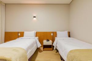 Tri Hotel Antônio Prado客房内的一张或多张床位