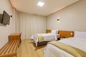 Tri Hotel Antônio Prado客房内的一张或多张床位