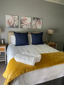 a bedroom with a bed with two towels on it at Ataria Place in Cradock