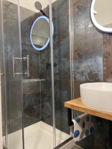een badkamer met een douche en een wastafel bij Apartments M GREGOR ideal for relaxing holidays in Baška
