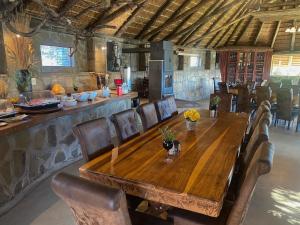 a dining room with a wooden table and chairs at Onjala in Eorondemba