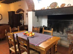 a table with a bowl of fruit on it in a room with a fireplace at Ca' Vamperti in Cigliano
