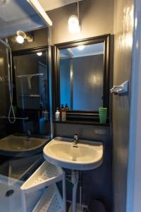 a bathroom with a sink and a mirror at 3-bedroom condo with indoor fireplace in Nyland