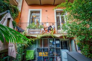 a building with a balcony with plants on it at Casa Barcelo Hostel Barcelona in Barcelona
