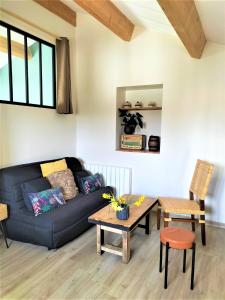 a living room with a couch and a table at Gites à Moussan ,Domaine de la barque à 5 mins de Narbonne in Moussan