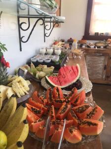 a table topped with lots of different types of fruit at Pousada Dom Xavier in Tiradentes +159 photos