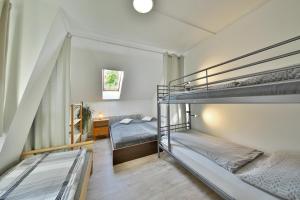 two bunk beds in a room with a bedroom at Penzion Kairos in Klokočí