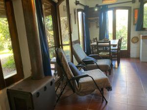 a living room with chairs and a wood stove at Alba Luz in La Paloma