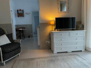a living room with a television on a dresser at La Casita in Pau