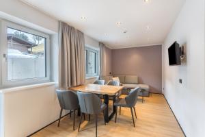 a dining room with a table and chairs and a couch at Luisalle Top 2 in Auffach