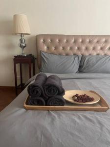 ein Tablett mit Handtüchern und einem Teller Essen auf dem Bett in der Unterkunft Perfect Marina Stay @ Strait Quay 6 Pax Max in Bagan Jermal