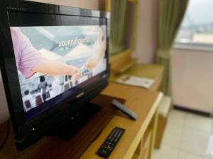 a television with a video game on the screen at Mike's Condo in Si Racha