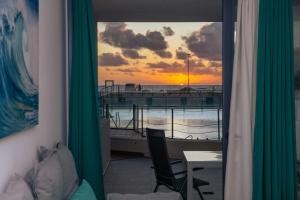 a room with a window with a view of a pier at Calypso II by Sea You There Fuerteventura in Cotillo