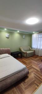a bedroom with two beds and a couch in it at Уютная квартира возле CITY Mall in Zaporozhye