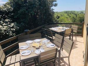 a table with plates and glasses on a patio at Amazing VILLA with Exceptional Panoramic views over Dunes protected natural site and Sea - Entire House or apt in Le Touquet-Paris-Plage