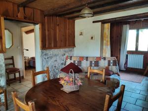 a living room with a wooden table and a couch at GITE PROVENCE LUBERON -PACA- Acces PMR-ANCV in Revest-des-Brousses