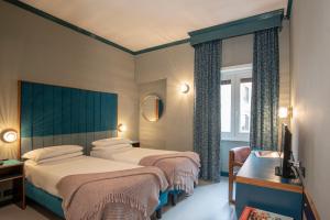 een hotelkamer met 2 bedden en een raam bij Hotel Milani in Rome