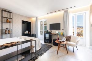 1 dormitorio con 1 cama, 1 mesa y 1 silla en Le Dortoir Boutique Suites en Niza