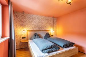 a bedroom with a bed with blue pillows on it at Luisalle Top 4 in Auffach