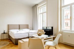 a hotel room with a bed and a table and chairs at Apartment Brno in Brno
