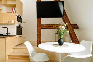 a kitchen and dining room with a white table and chairs at Apartment Brno in Brno