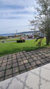 a brick walk way with a field of grass at Bryson's Bed and Breakfast in Baddeck