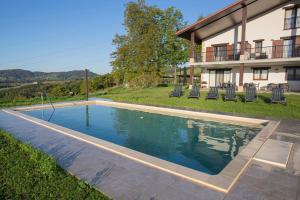 a swimming pool in the yard of a house at Agroturismo Basitegi in Urnieta