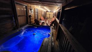 a blue tub in a room with a table and chairs at Rustic Cabin in Sevierville