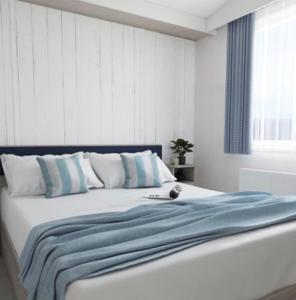 a bedroom with a bed with a blue blanket on it at The Telford Van - Beautiful, luxury static caravan in Aberlour