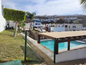a picnic table on a fence next to a swimming pool at Relaxing Place Near the Sea in Ensenada