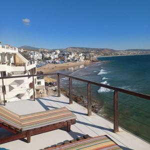 a balcony with a view of the beach and the ocean at Balcon sur l'ocean in Taghazout