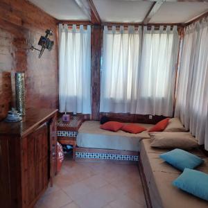 a small room with a bed and a window at Balcon sur l'ocean in Taghazout
