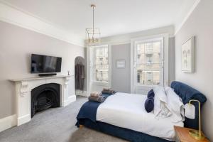 a bedroom with a large bed and a fireplace at Bladud Buildings in Bath