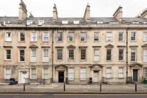 an old building in a city with a street at Bladud Buildings in Bath