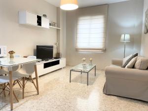 a living room with a couch and a table at Apartamento Antón Gómez in Lucena